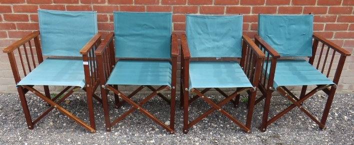 A set of four vintage folding director's chairs with green material to back and seats and complete