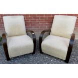 A pair of Art Deco style lounge armchairs with cream upholstery and in good condition.