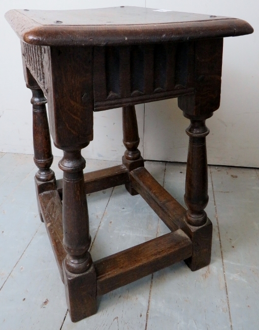 A 17th Century and later country oak joint stool with a carved linen fold frieze over turned - Image 4 of 8