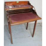 An Edwardian compact ladies writing desk with a canter levered lift up top revealing a fully fitted