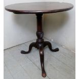 A Georgian mahogany tilt top tripod wine table terminating on splayed legs.