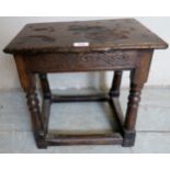 A 17th Century and later oak joint stool with a carved frieze over turned supports.