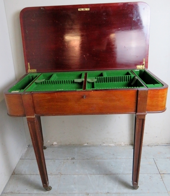 A late 19th century mahogany cutlery table with a lift up top revealing internal fittedlined