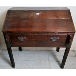 A Georgian country oak clerks desk with a lift up top opening to reveal a fitted interior with