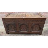 A late 18th / early 19th Century oak coffer with panelled top and sides and having an intricately