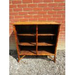 An early 20th Century colonial style bamboo open bookcase with three shelves.