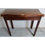 A Georgian mahogany turn over card table with a serpentine shaped top over chamfered legs.
