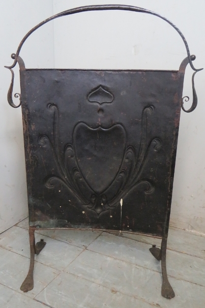 A decorative Art Nouveaux fire screen with an embossed copper panel inset in an ironwork frame. - Image 2 of 2