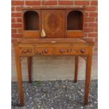 A vintage Georgian design Bonheur du jour with a central cupboard revealing internal compartments