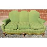 A 19th century oak framed three seater 'hump-back' sofa upholstered in a green stripe material with