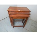 A nest of three graduated Edwardian design mahogany crossbanded side tables.