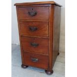 A Victorian mahogany bedside cabinet with four graduated deep drawers having decorative handles