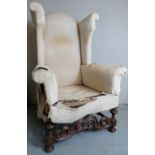 A fine quality 19th century high-back wing armchair in a late 17th Century-revival taste,
