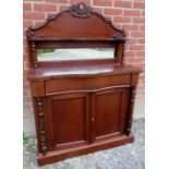 A Victorian mahogany chiffonier sideboard with an arched top having a mirror beneath a small shelf