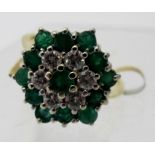 An 18ct gold diamond and emerald cluster