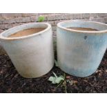 Two decorative garden plant pots with a