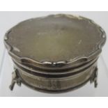 A silver circular ring box/trinket box,