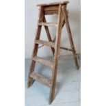 A vintage folding pine step ladder set.