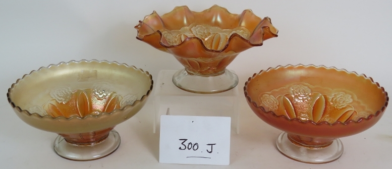 Three glass orange carnival glass bowls