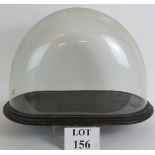 A large antique glass dome and base, dome 46cm wide, 24cm deep, 31cm high.