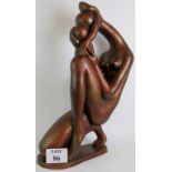 A large decorative semi-abstract bronzed ceramic sculpture of a mother and child; signed: Austin.