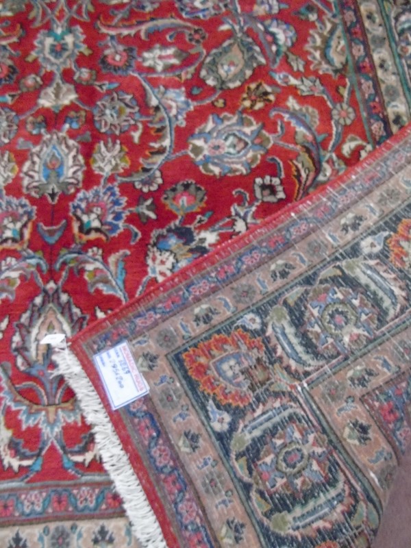 A large Persian carpet on red ground. Possibly Kashan. 2.95m x 2.00m. - Image 4 of 4