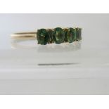 A Kenyon 14ct yellow gold Tsavorite garnet ring, comprising nine VSI oval stones.