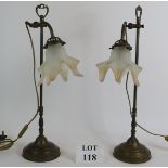 A pair of brass Art Nouveau style rise and fall desk or table lamps with directional heads and