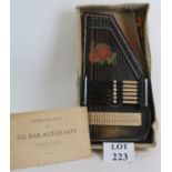 A vintage Zither auto harp in original box with instructions and original key.