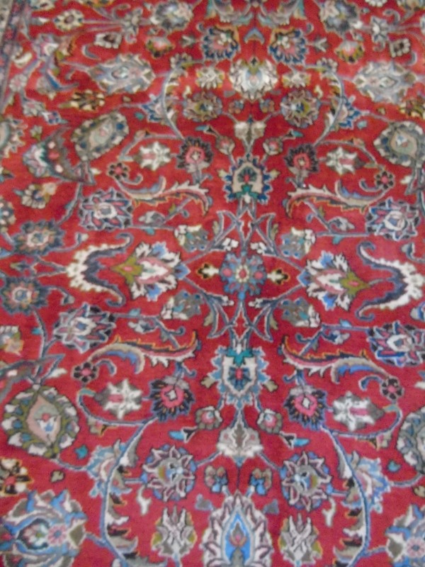 A large Persian carpet on red ground. Possibly Kashan. 2.95m x 2.00m. - Image 3 of 4