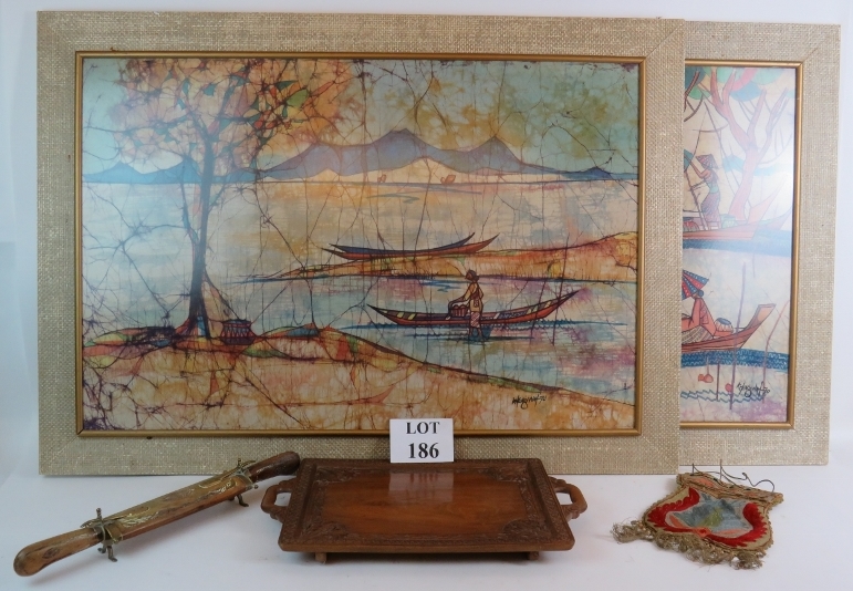 A pair of large framed decorative Batik panels, signed and dated 1970, a carved teak Eastern tray,