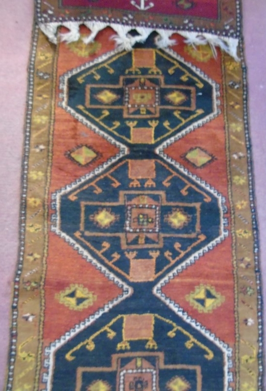 An early-mid 20's Turkish runner with repeated central motif on a red ground and tan border. - Image 3 of 4