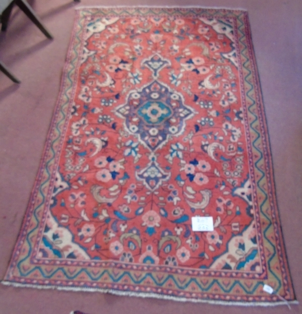 A Hamadan rug on red ground with central motif surrounded by flowers. - Image 2 of 4