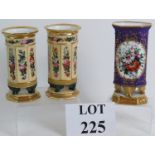 A pair of highly decorated and gilded column Continental porcelain vases with winged lion feet,