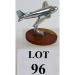 A cast alloy car mascot or desk piece in the form of an aeroplane, possibly a Dakota DC3.