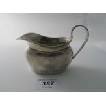 A Georgian style cream jug with Chester hallmarks, date letter worn, approx 73 grams/2.3 troy oz.