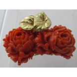 A finely carved large coral clasp with yellow metal mounts depicting leaves transformed into a