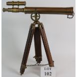 A reproduction brass telescope with adjustable wooden tripod. A perfect gentleman's study piece.