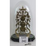 A fine brass skeleton clock under a glass dome on an ebonised wooden stand.