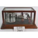 An Early 20th Century Negretti and Zambra oak cased barograph with spare sheets.