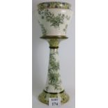 A late Victorian Doulton Burslem 'Beverley' jardiniere and stand decorated with green and yellow
