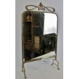 An antique Art Nouveau mirrored fire screen with bevelled glass and brass frame and feet.