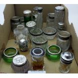 A collection of mainly silver top scent bottles, a collection of cut glass silver rimmed salts,