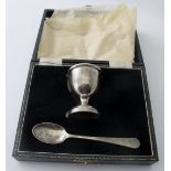 A cased silver egg cup and spoon, Birmingham 1958 and 1959, approx 32 grams/1.02 troy oz.