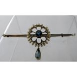 An Art Deco white gold bar brooch, the circular centre with openwork design set with an aquamarine,