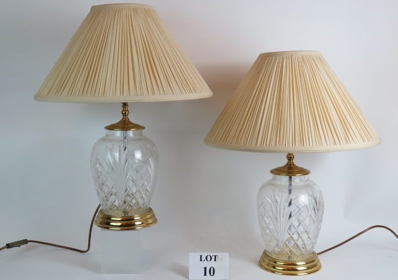 A pair of large Waterford crystal glass lamp bases with pleated Ivory shades. Bases: 32cm tall.