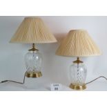 A pair of large Waterford crystal glass lamp bases with pleated Ivory shades. Bases: 32cm tall.