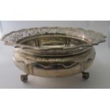 A large circular heavy silver fruit bowl with pierced decoration and scroll acanthus leaf decorated