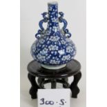 An 18th Century Chinese blue and white bottle vase with dragon handles.