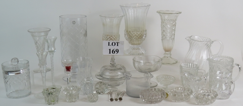 A large collection of vintage and antique glassware including vases, jugs, salts and candlesticks.